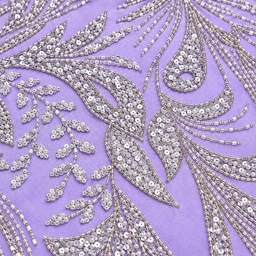Close-up of silver bead and sequin botanical embroidery on lilac fabric
