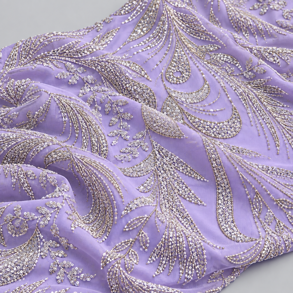 Lilac embroidered fabric draped in soft folds, light grey background